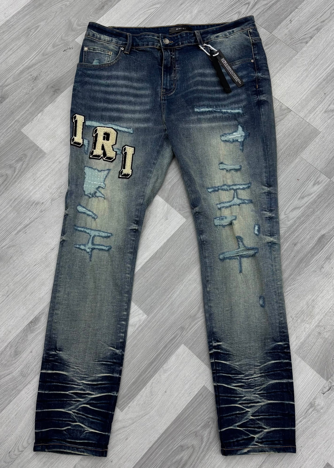 Amiri Varsity Logo Ripped Blue Jeans