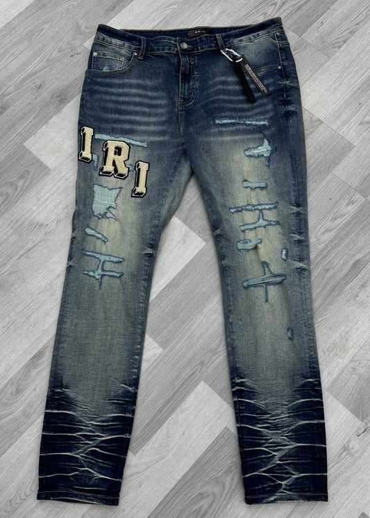 Amiri Varsity Logo Ripped Blue Jeans